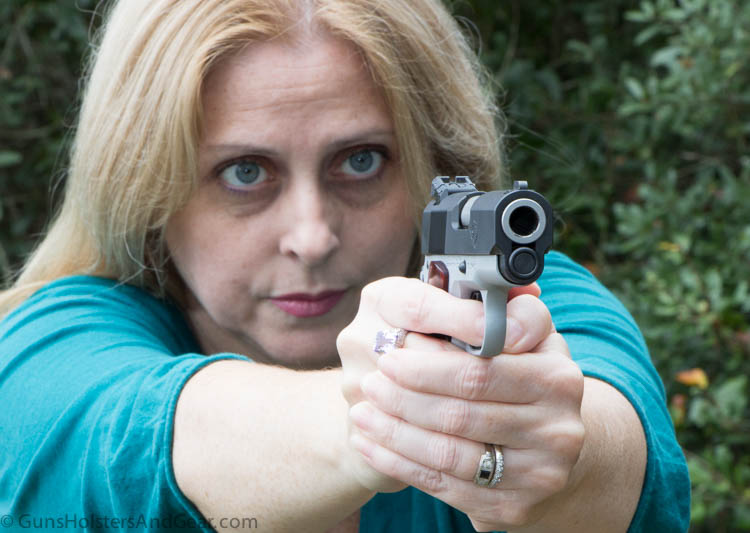 beautiful woman shooting 1911 pistol