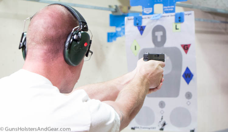 A student firefighter trains with his personal security duty gun at the indoor shooting range on this rainy day. The well lit interior lighting offers an excellent opportunity to train.