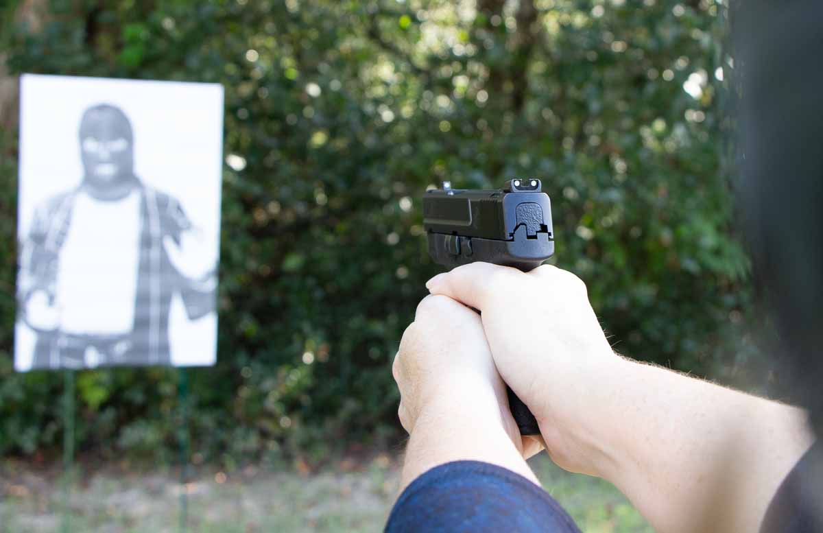woman testing the smith and wesson shield pistol