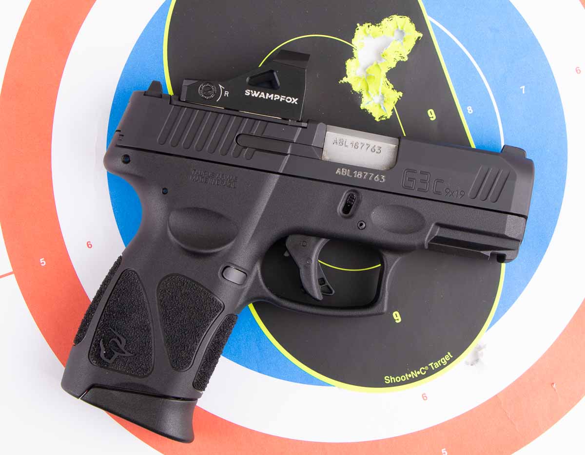 range testing the Taurus G3c 9mm pistol with a red dot sight