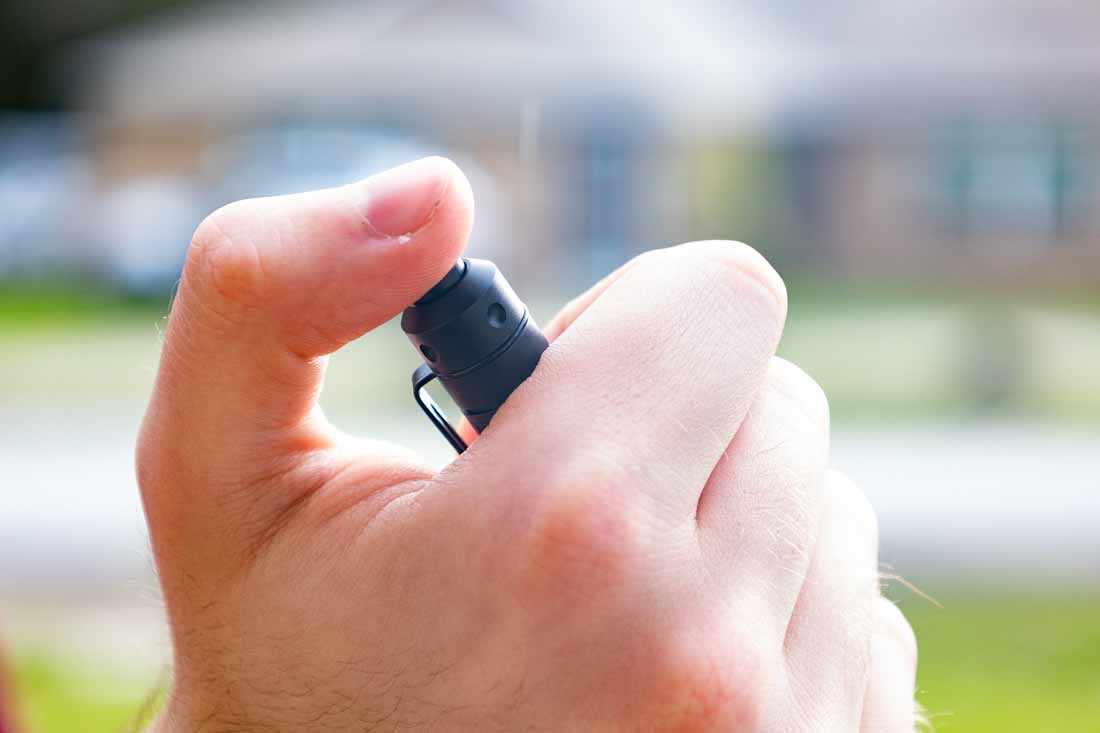 Close-up view of the tail switch on the Princeton Tec Alloy-X flashlight. The switch is mounted at the rear of the slim black aluminum body, with a textured surface for improved grip. It controls the flashlight’s three brightness modes—medium, low, and high—in that order. A full press locks the light on, while a half press is designed for momentary activation, though this function may vary between units. The switch is positioned for comfortable thumb operation, making it suitable for both everyday and tactical use. Its firm resistance helps prevent accidental activation when carried in a pocket. The image highlights the control point of the Alloy-X, showing its ergonomic and durable design.