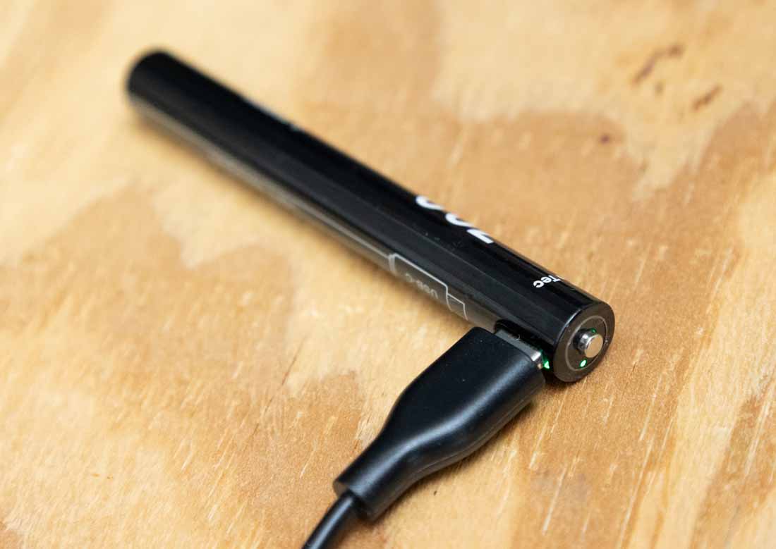 The image shows a USB-C cable plugged directly into the 10900 lithium-ion rechargeable battery used in the Princeton Tec Alloy-X flashlight. The battery’s built-in charging port eliminates the need for an external cradle or separate charger. This feature allows charging from a variety of sources, including wall adapters, laptops, or portable power banks. The battery is rated at 700mAh and 3.7V, capable of delivering up to 400 lumens in the flashlight. The setup is compact and ideal for travel, work, or emergency use. This charging method ensures the battery can be topped up anywhere with a standard USB-C cable. The image highlights the Alloy-X’s focus on convenience and versatility in power management.