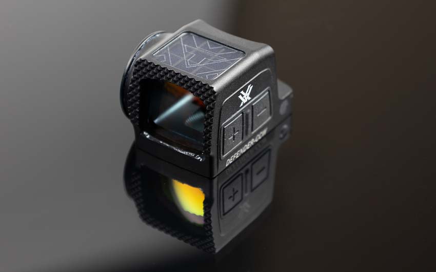 Vortex Defender-CCW Enclosed red dot sight showing integrated solar panel on top housing for backup power and extended battery life. The solar-powered red dot optic combines ambient light harvesting with traditional battery operation for reliable dot illumination during concealed carry. Defender-CCW solar panel technology provides redundant power source ensuring the pistol optic remains functional even with depleted battery. Enclosed red dot sights with solar backup offer enhanced reliability for defensive handgun applications where dot activation must be guaranteed. The top-mounted solar cell works in conjunction with motion-activated technology and auto-shutoff features to maximize operational runtime. Vortex CCW red dot solar capability extends the 9,000-hour battery life even further for everyday carriers. Pistol optics with dual power systems like the Defender-CCW deliver duty-grade redundancy at affordable price points. Solar-assisted enclosed reflex sights provide peace of mind that your concealed carry optic will function when needed most.