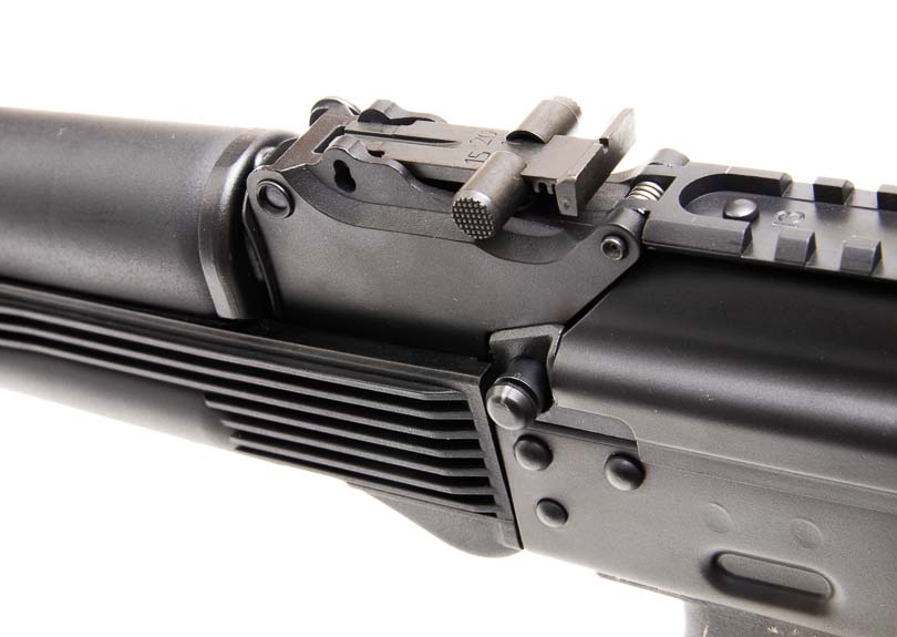 A close-up image captures the KR-9's rear sight aperture and adjustment mechanism for precision aiming. The KR-9 rifle incorporates proven Soviet-inspired sight designs. Nine-millimeter carbines benefit from durable iron sight construction. The KUSA 9mm pistol caliber carbine allows windage and elevation adjustments. Semi-automatic firearms require rugged sighting systems for accuracy. Defensive carbines maintain zero through extended shooting sessions.
