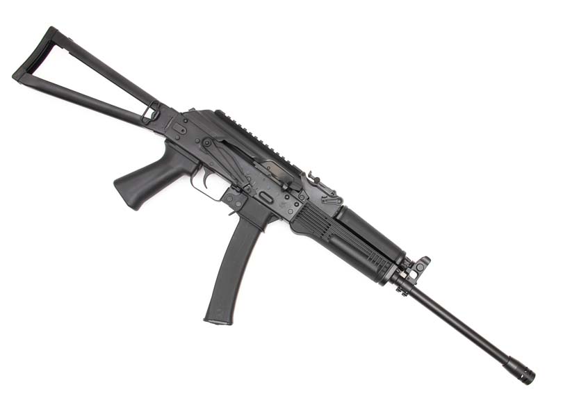A left-side profile photograph shows the complete Kalashnikov KR-9 rifle with its folding stock and AK-style receiver. The Kalashnikov KR-9 features authentic Soviet-inspired design elements. Pistol caliber carbines utilize skeletonized folding stock configurations. The KUSA 9mm pistol caliber carbine includes traditional AK safety selectors. Blowback-operated firearms incorporate simple mechanical systems. American-manufactured carbines blend classic styling with modern reliability.