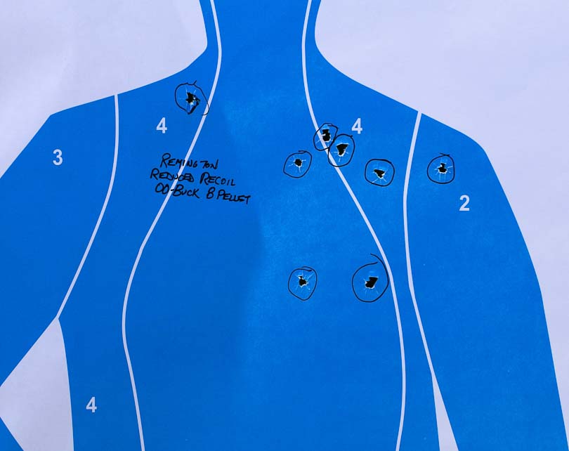 A human silhouette target displays a tight shot pattern from the Kalashnikov Komrad at fifteen yards using Remington Law Enforcement Reduced Recoil 8-pellet 00 buckshot, with all pellets concentrated in the torso region demonstrating effective defensive accuracy. The Kalashnikov Komrad review documents pattern performance meticulously. Komrad 12 shotgun evaluation measures pellet spread precisely. Reduced recoil buckshot delivers tighter groupings. Defensive shotgun patterns maintain torso hits effectively. Remington LE ammunition produces 7.50-inch spreads.