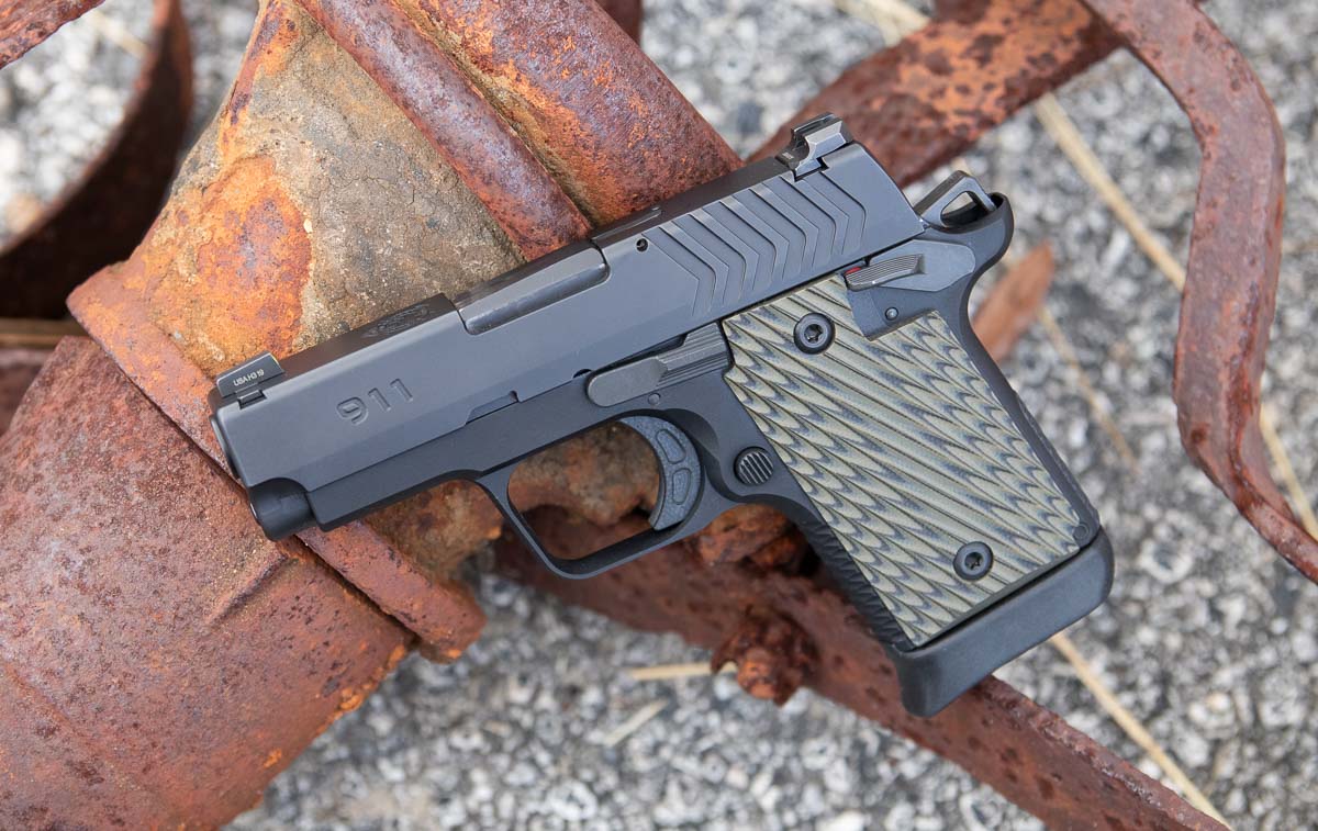 A Springfield Armory 911 9mm pistol displayed against a neutral background, showing its compact 1911-style profile with ambidextrous thumb safety and Pro-Glo tritium sights. The Springfield 911 9mm review demonstrates exceptional reliability for concealed carry applications. Micro-compact 1911 pistols offer single-action triggers with crisp breaks. The Springfield Armory 911 features a 7075-T6 aluminum frame for lightweight durability. Defensive handguns chambered in 9mm provide effective stopping power in compact packages. Small frame 1911-style pistols deliver familiar ergonomics for everyday carry.