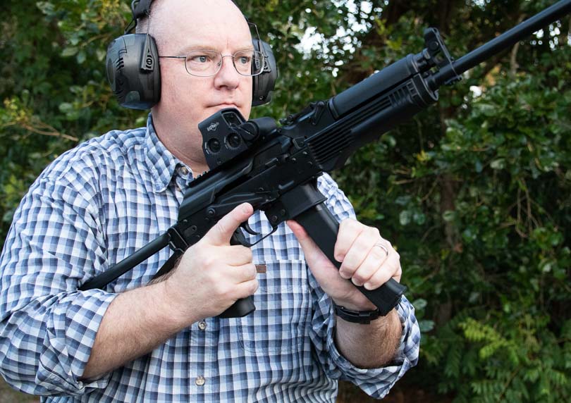 The reviewer loads the KR-9 carbine with ammunition during comprehensive field evaluation sessions. The KR-9 rifle demonstrates intuitive magazine insertion procedures. Nine-millimeter carbines accommodate various magazine capacity options. The KUSA 9mm pistol caliber carbine feeds common Parabellum ammunition reliably. Semi-automatic firearms benefit from secure magazine lockup mechanisms. Defensive carbines require consistent feeding performance under testing.
