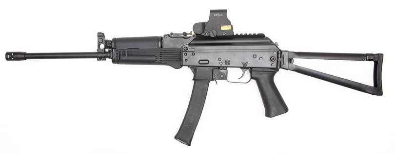 A left-side profile view presents the complete Kalashnikov KR-9 rifle used throughout the comprehensive review testing. The Kalashnikov KR-9 exhibits clean finish and quality riveting work. Pistol caliber carbines demonstrate American manufacturing standards. The KUSA 9mm pistol caliber carbine features hinged receiver cover with Picatinny rail. Blowback-operated firearms showcase robust construction methods. AK-pattern carbines maintain authentic Soviet-inspired aesthetics.