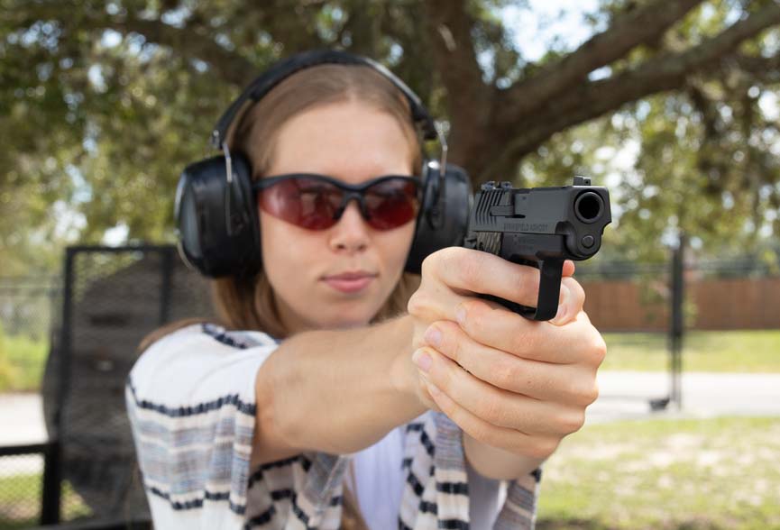 A shooter fires the Springfield 911 9mm pistol at an outdoor shooting range, demonstrating proper grip technique and sight alignment during live-fire evaluation. The Springfield 911 9mm review includes extensive range testing with various ammunition loads. Defensive pistol reliability testing requires hundreds of rounds through multiple magazines. The Springfield Armory 911 functions flawlessly with Federal HST and Liberty Ammunition. Micro-compact handguns demand proper recoil management for accurate follow-up shots. Range performance validates concealed carry pistol suitability for personal defense scenarios.