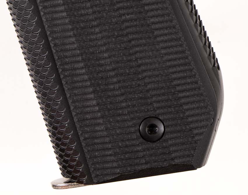 evaluating the texture of the grip panels and backstrap on Ed Brown 9mm 1911