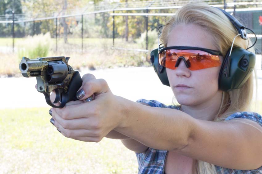 pretty blonde woman shooting the Charter Arms Undercover revolver during testing on the shooting range